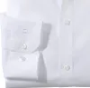 A close-up view of a white men's dress shirt, focusing on the cuff and buttons. Produktbild-Vorschau