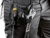 A close-up view of a person's work pants with tools attached. Anteprima dell’immagine prodotto