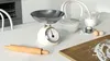 A kitchen counter with baking ingredients and tools. Voir les images du produit