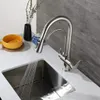 A kitchen sink with a faucet running water into it. There is a yellow bowl and a vase with dried flowers on the counter. Náhled obrázku produktu