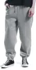 A person wearing grey sweatpants and black sneakers. Produktbild-Vorschau