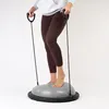 A person is standing on a balance trainer with resistance bands. Náhled obrázku produktu