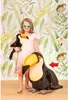 A young girl is posing with two toucan plush toys in front of a tropical-themed wallpaper. Voir les images du produit