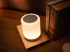 A bedside table with a lamp and books. Voir les images du produit