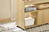 A close-up view of a wooden rolling storage cart with books and a basket on its shelves. Podgląd zdjęcia produktu