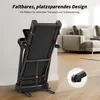 A foldable treadmill is shown leaning against a wall in a room with a sofa in the background. A close-up inset shows a detail of the treadmill's wheel. Produktbild-Vorschau