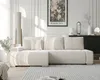A modern living room with a large beige sectional sofa as the focal point, bathed in natural light. Produktbild-Vorschau