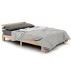 A wooden bed frame with gray bedding and pillows, set against a white background. Náhled obrázku produktu