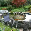 A solar-powered pond aerator is shown next to a pond with koi fish. Náhled obrázku produktu