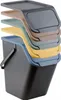 A stack of colorful lids and a black trash can. Podgląd zdjęcia produktu