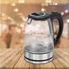A glass electric kettle with water boiling on a wooden table, with a blurred background of lights. Produktbild-Vorschau