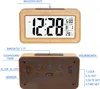 A digital alarm clock with a wood-grain finish is shown from the front and back, with labels pointing to its features and buttons. Produktbild-Vorschau