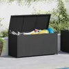 An open black poly rattan storage box filled with colorful cushions and pool floats, placed on a tiled patio next to a swimming pool. Anteprima dell’immagine prodotto