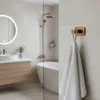 A modern bathroom with a towel hanging on a hook. Anteprima dell’immagine prodotto