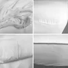 A collage of four close-up images showing the texture and details of a white fitted sheet. Produktbild-Vorschau