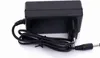 A black power adapter with a coiled cord and a connector plug, shown against a white background. Anteprima dell’immagine prodotto