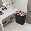 A laundry basket filled with clothes sits next to a bathroom vanity. Náhľad obrázku produktu