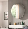 A modern bathroom with a round mirror above a sink. Produktbild-Vorschau