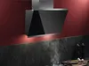 A modern kitchen scene with a black range hood mounted on a red wall above a dark countertop. Produktbild-Vorschau