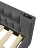 A close-up view of the headboard of a gray upholstered daybed, showing a USB charging port. Voir les images du produit