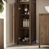 A close-up view of a wooden bathroom cabinet with its door open, revealing shelves stocked with toiletries. Podgląd zdjęcia produktu