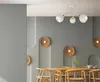 A dining room with a modern chandelier and decorative wall panels. Produktbild-Vorschau