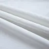 A close-up view of white fabric with folds and shadows. Náhled obrázku produktu