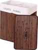 A laundry basket with two compartments and a lid. Produktbild-Vorschau
