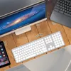 A desk setup with a computer monitor, keyboard, and smartphone on a wooden surface. Produktbild-Vorschau