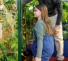 A young girl and an adult are tending to plants in a greenhouse. Náhled obrázku produktu