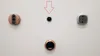 Three smart doorbells and a peephole lens are mounted on a white wall. Produktbild-Vorschau