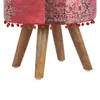 A close-up view of the bottom part of a round stool, showing its patchwork fabric seat and wooden legs. Produktbild-Vorschau