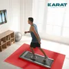 A man is exercising on a treadmill in a room with blinds and a TV. Náhled obrázku produktu