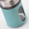 Close-up of a teal colored spice jar with a silver lid and a glass window. Podgląd zdjęcia produktu