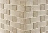A close-up view of the woven texture of a beige laundry basket, showing the corner where two sides meet. Podgląd zdjęcia produktu