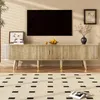 A TV stand with a television and decorative items in a living room setting. Anteprima dell’immagine prodotto