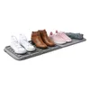 A shoe drying mat with various shoes and a piece of fabric on it. Náhled obrázku produktu