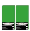 Two green fitted sheets are shown side-by-side against a white background. Each sheet has a black label at the bottom with product information and branding. Produktbild-Vorschau