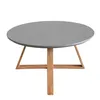 A round coffee table with a gray top and wooden legs, isolated on a white background. Náhled obrázku produktu
