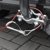 A close-up shot of a red trailer breakaway cable with a silver carabiner and ring attached to a metal hitch clamp. Produktbild-Vorschau