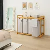A bedroom scene with a laundry basket, mirror, and bed. Anteprima dell’immagine prodotto
