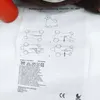 A close-up of an instruction manual for a bouncing animal toy, with a portion of the toy and an orange object visible. Produktbild-Vorschau