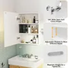 A white bathroom cabinet with its door open, displaying various toiletries and bottles on its shelves. The cabinet is positioned above a white sink. Produktbild-Vorschau