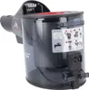 A close-up, slightly angled view of a black and gray dustbin and filter assembly for a vacuum cleaner, with a red accent ring around the top opening. Instructional diagrams are visible on the side of the dustbin. Voir les images du produit