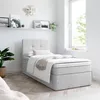 A bedroom scene with a bed, a plant, and artwork on the wall. Produktbild-Vorschau
