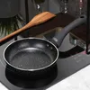 A frying pan and a wooden spatula are placed on a modern induction cooktop. Náhľad obrázku produktu