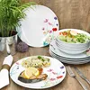 A table setting with a floral-themed dinnerware set, featuring a meal of salmon, rice, and salad. Produktbild-Vorschau