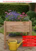 A wooden raised garden bed filled with colorful flowers, with a yellow watering can in front. Produktbild-Vorschau