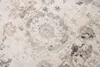 A close-up view of a textured rug with a faded floral pattern. Náhled obrázku produktu