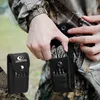 A person in camouflage clothing is shown taking a multi-tool out of a black pouch attached to their belt. Náhled obrázku produktu
